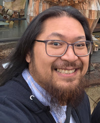 Ret wearing glasses and posing for a selfie