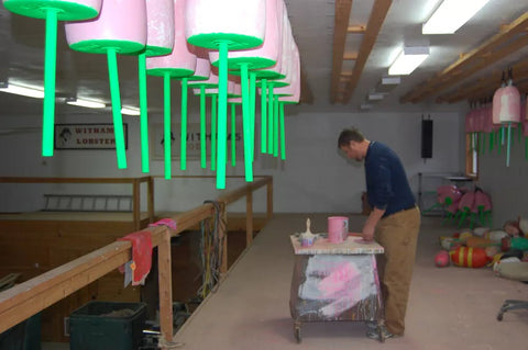 Josh Miller touches up his signature pink buoys during the winter.