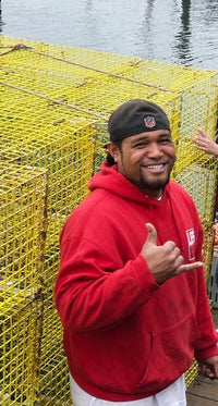 Denny Fiaalii in front of yellow lobster traps
