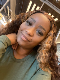 KeKe wearing a green shirt and posing for a selfie