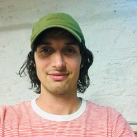 Kevin Casey: smiling wearing a green hat 