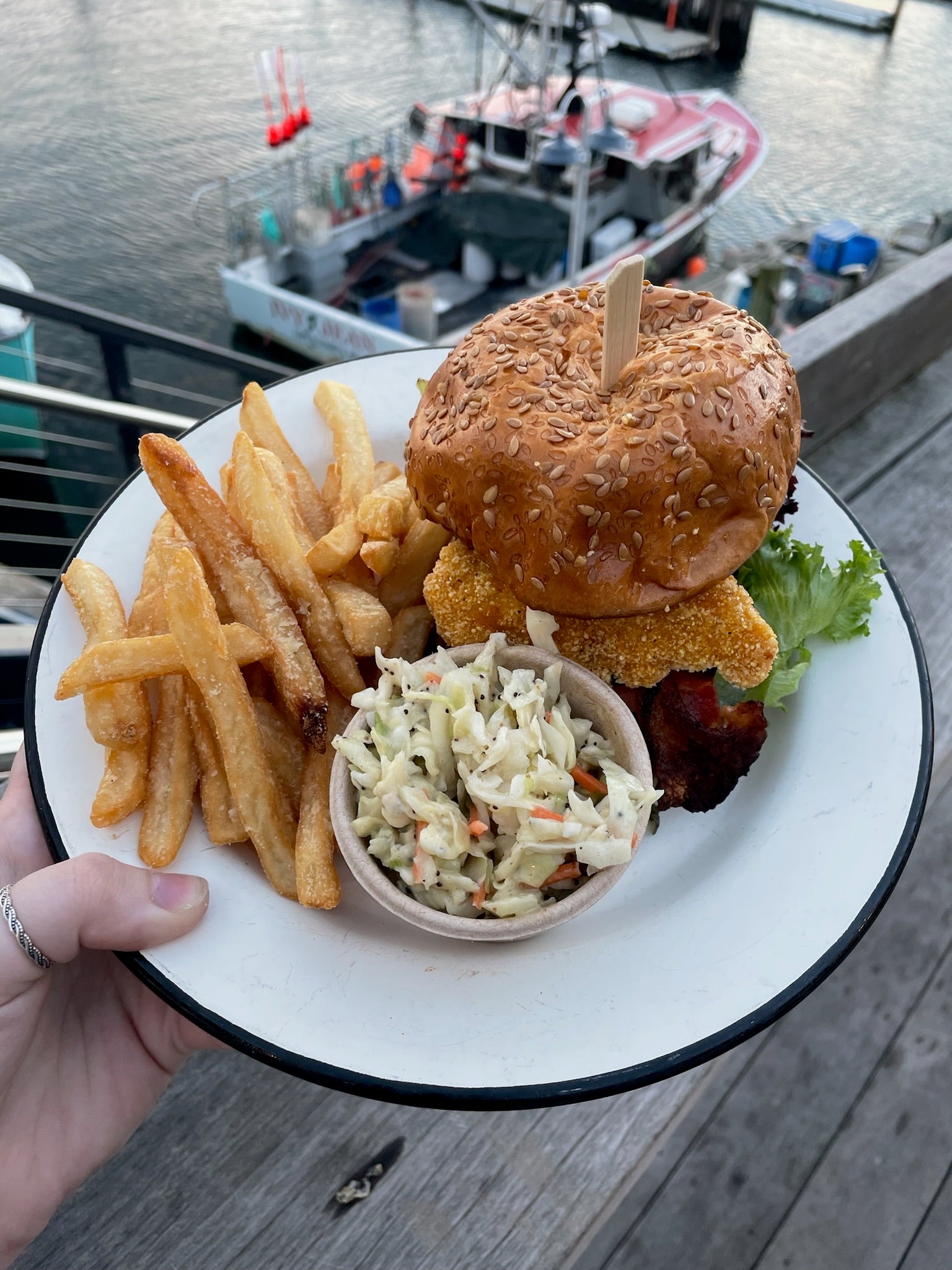 a plate with slaw, fries, and the fried chicken blt