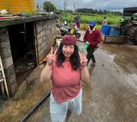 Pema posing outside and doing peace signs with her hands