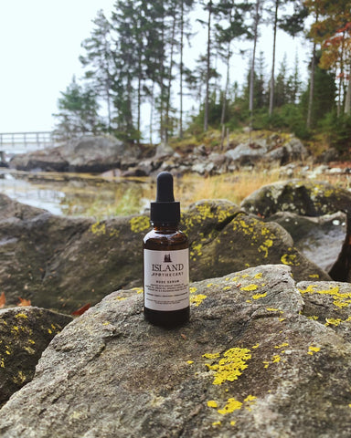 bottle of serum on rocks 