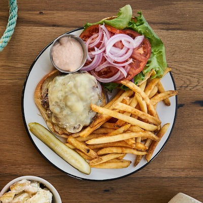 A burger and fries on a white plate