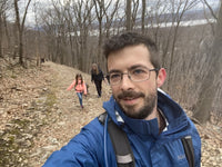 Shawn taking a selfie while hiking in the woods