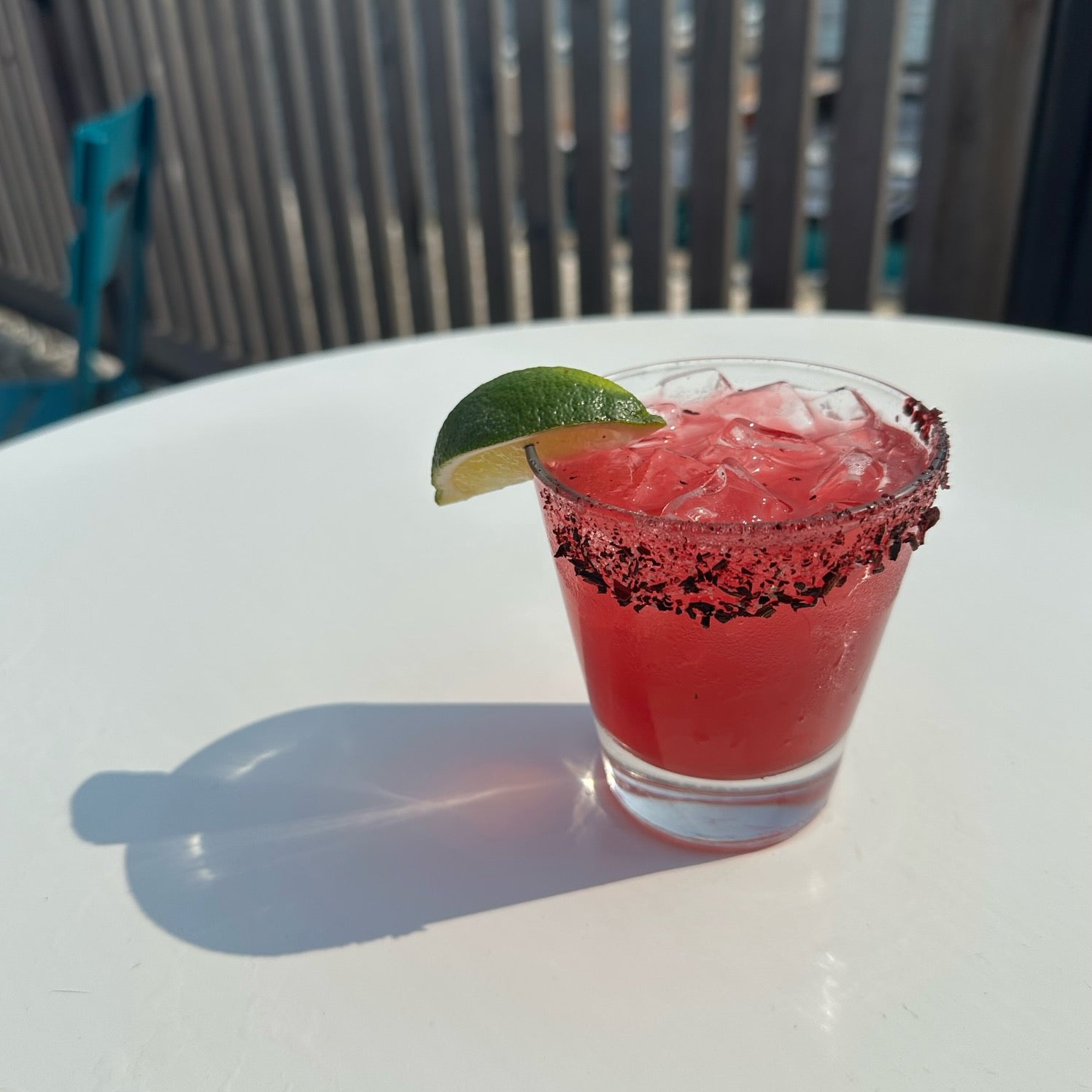 cocktail in a wine glass on the deck