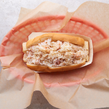 Crab Roll in a red basket lined with wax paper
