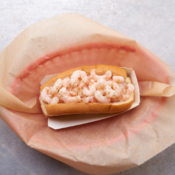 Shrimp Roll in a red basket lined with wax paper